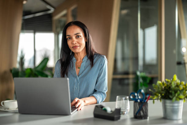 istock Confident Hispanic Businesswoman in Modern Office Setting 2151658537