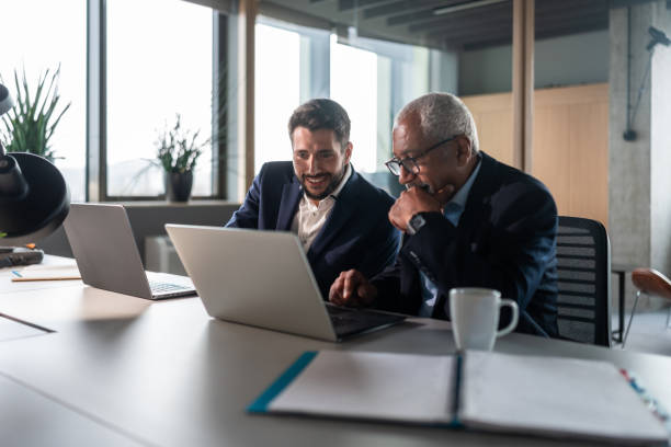 istock Diverse Senior Executive Mentoring Young Intern in Modern Office Setting 2151658601