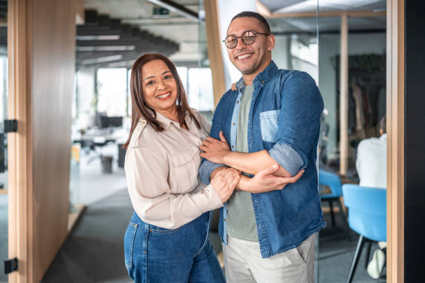 istock Smiling Hispanic Colleagues in Casual Office Attire 2151658617