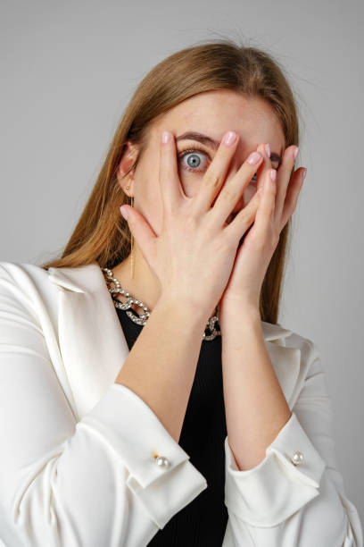 istock Young Woman Covering Her Eyes With Hands 2151660262