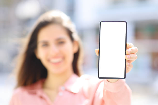 istock Elegant happy woman showing phone screen mock up 2151663260