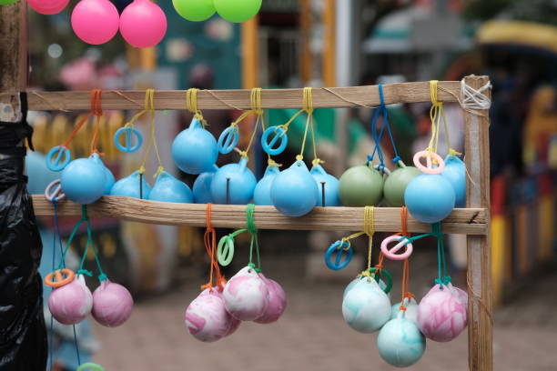 istock Latto-latto is a toy in the form of two plastic balls with a hard solid weight and a smooth surface tied by a string with a finger ring in the middle. Etek-etek, tek-tek, kletokan, katto-katto, nok-nok, toki-toki, tok-tak, tok-tok 2151663271