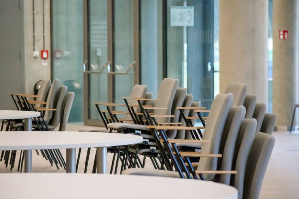 istock .round tables and stacked chairs in a restaurant 2151665645