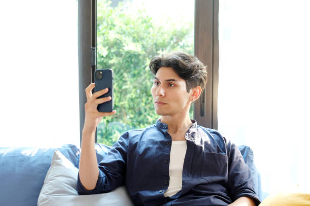 istock Young man scan his face for unlock his mobile phone, Face detection for verification on smart phone 2151666322