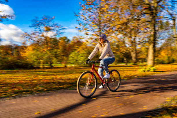 istock Motion Blur. Woman riding bicycle in city park 2151668021