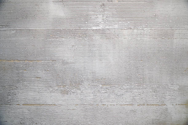 Gray decorative plaster on the wall with pressed horizontal stripes. Plaster background