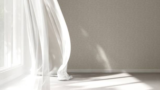 istock Empty beige wall room in sunlight from window, blowing white sheer, brown blackout curtain tree shadow on baseboard, carpet floor 2151670234