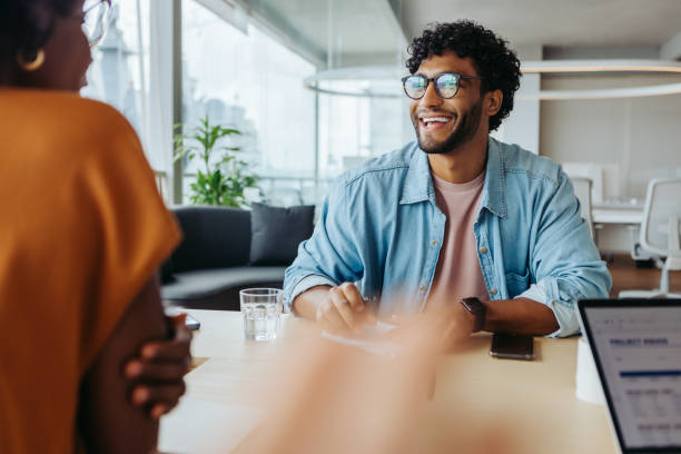 istock Modern office with business people discussing ideas in a productive meeting 2151670628