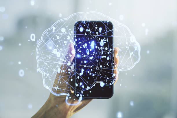 istock Creative artificial Intelligence concept with human brain hologram and hand with phone on background. Multiexposure 2151671806
