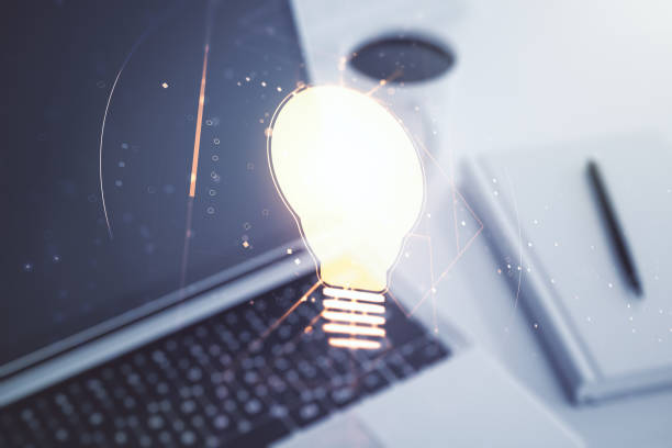 istock Creative light bulb hologram on modern laptop background, idea concept. Multiexposure 2151671942