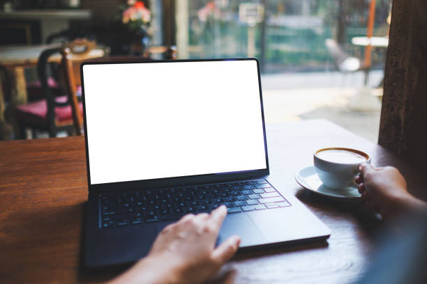 istock Mockup image of a woman working on laptop computer with blank white desktop screen while drinking coffee in cafe 2151672828