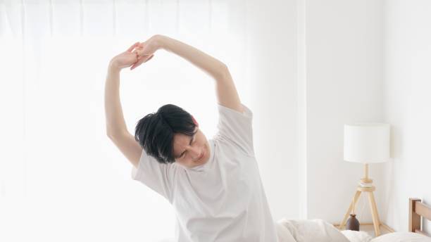 istock A man wakes up and stretches 2151673529