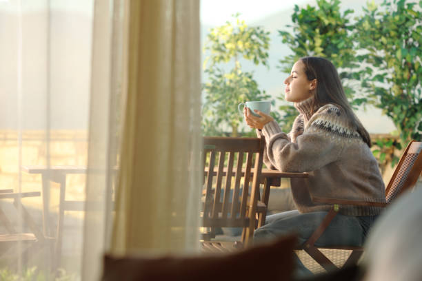 istock Woman sitting in a terrace relaxing and drinking coffee 2151674628
