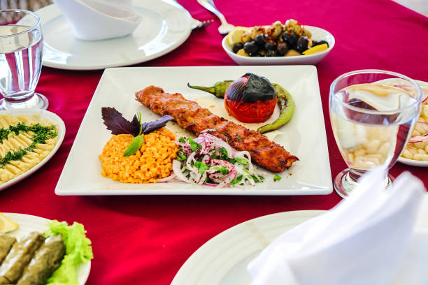 A close-up photo of a plate filled with food, placed on a vibrant red tablecloth.