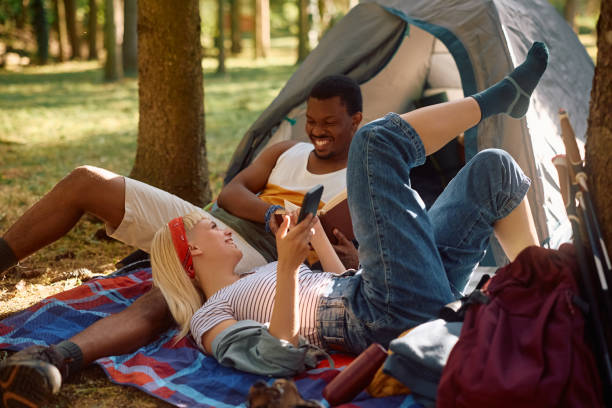 istock Young happy couple talking while enjoying in camping in nature. 2151678038