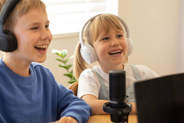 istock Joyful siblings sharing a laugh while recording a podcast at home. Blogging 2151678429
