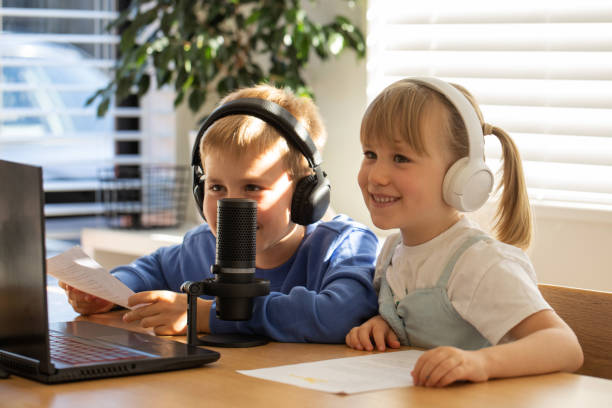 istock Joyful siblings sharing a laugh while recording a podcast at home. Blogging 2151678434