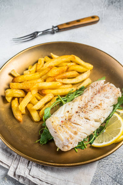istock Fried cod fish fillet served with french fries. White background. Top view 2151678549