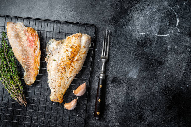 istock Grilled sea red perch fillet, Snapper fish on a rack. Black background. Top view. Copy space 2151678633