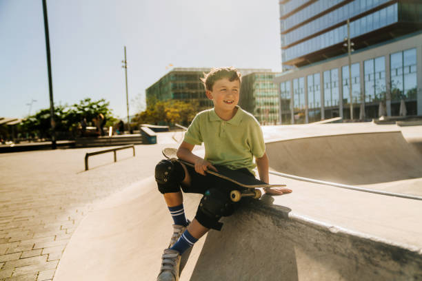 istock A young boy sitting on a skateboard 2151678945