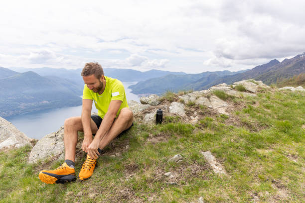 istock Hiker Preparing for Adventure in Mountainous Landscape 2151680433