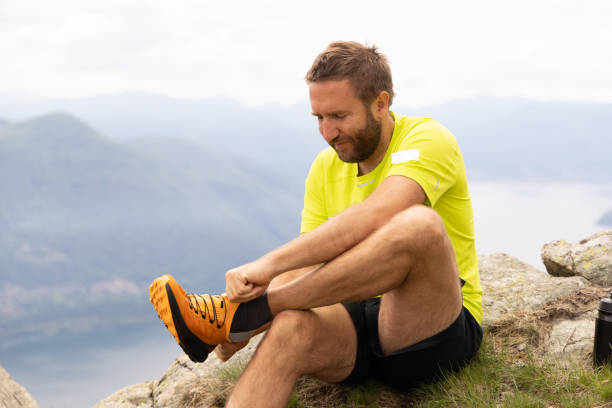 istock Hiker Adjusting Boot on Rocky Mountain Overlook 2151680468