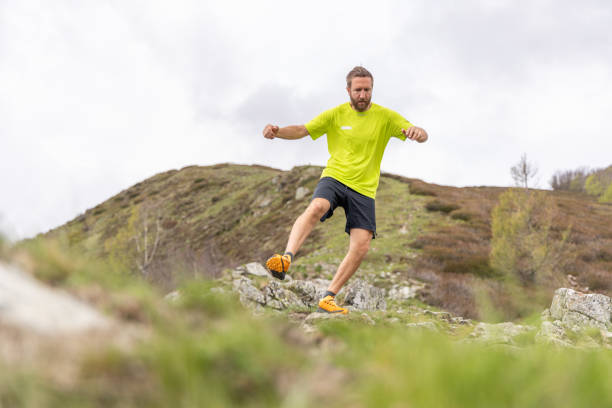 istock Trail Runner Leaping Across Mountain Terrain 2151680758