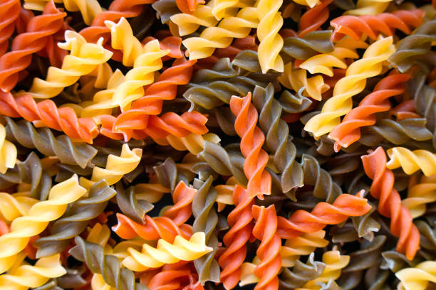 Fusilli paste spiral shape. Close up. Natural pasta background. Top view. Selective focus.