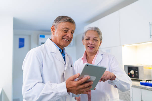 istock Senior Medical Professionals Reviewing Data on Tablet 2151681695