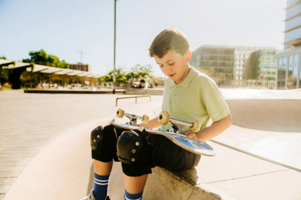 istock A young boy sitting on a skateboard 2151681874
