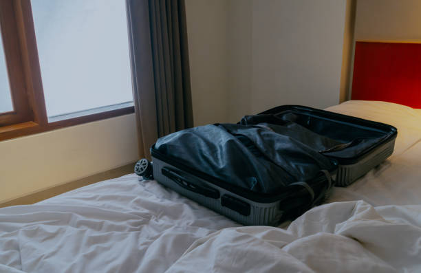 istock An open suitcase on the hotel bed. 2151682147