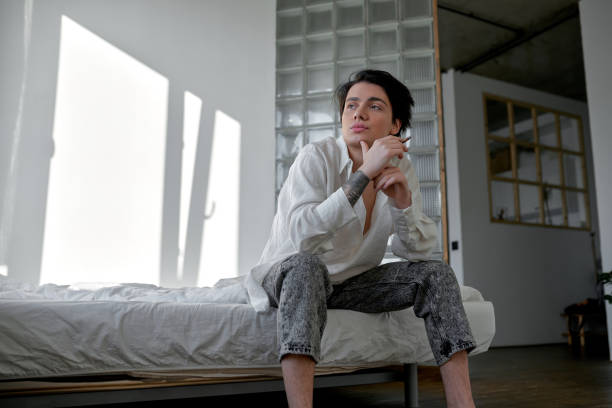 istock young unhappy exhausted man sitting at home 2151684732