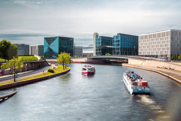 tourboats on the spree river in modern central Berlin  at sunny day