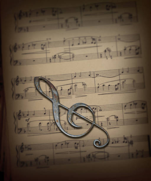 Sheet music with ribbon and treble clef symbol in warm light