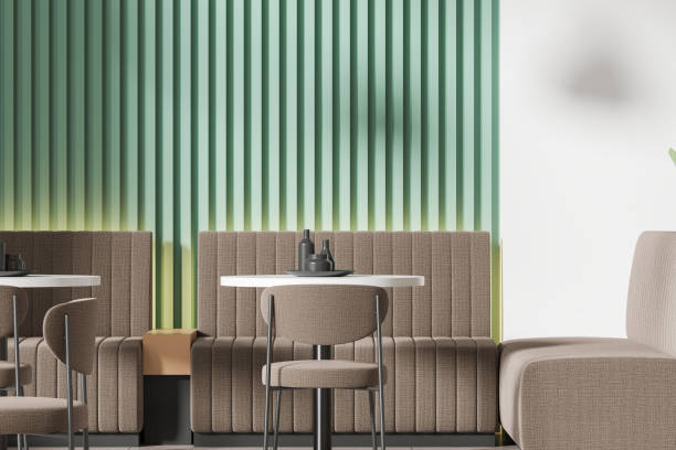 istock Stylish modern cafe interior with chairs and table with couch, green wall 2151686553