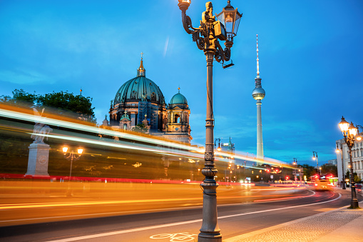 long exposure of city bus  in front of  cathedral and tv-tower in Berlin at blue hour