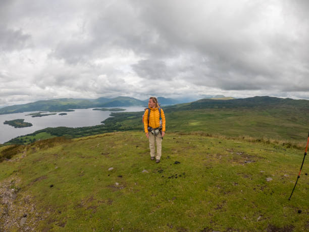 istock Thoughtful Hiker on Highland Trail Overlooking Expansive Lake View 2151687515