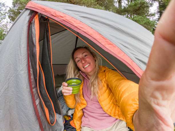 istock Welcoming Camper Enjoying Her Morning in a Tent 2151687584