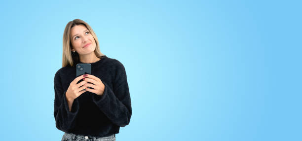 istock Thoughtful young woman with phone 2151688356