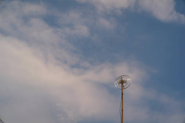 istock Round television antenna against a blue sky 2151690897