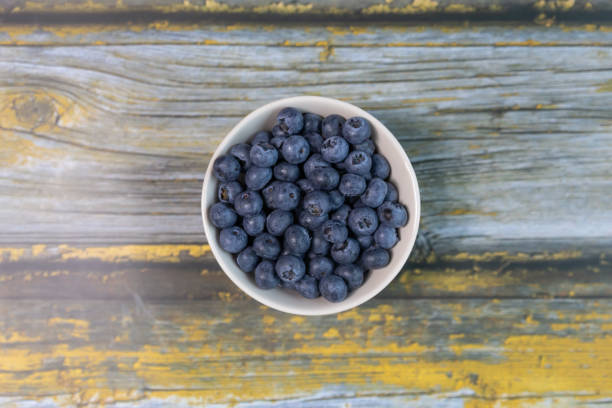 Blueberries isolated on wood table background, close-up, front view, top view,