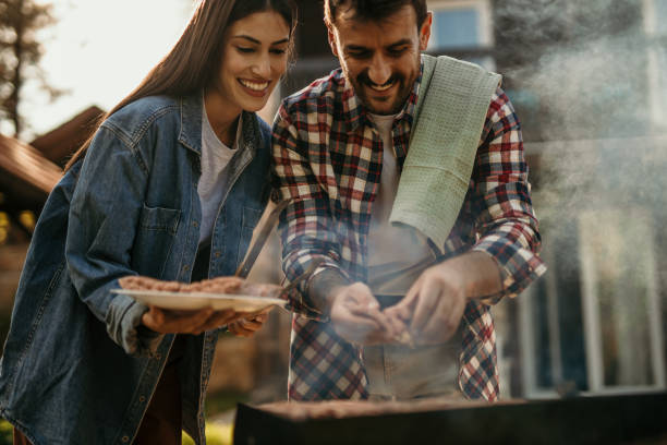 istock Beautiful woman and handsome man having barbecue 2151692224