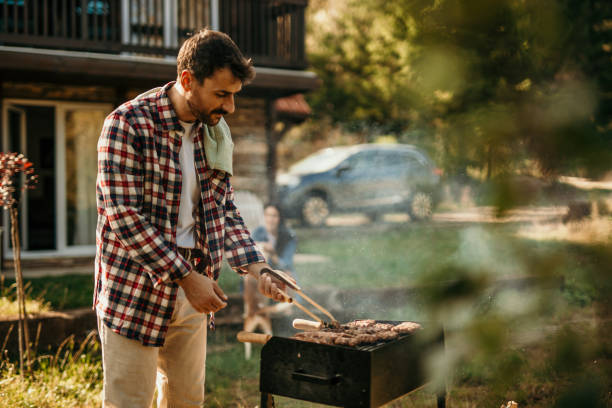 istock Handsome male preparing barbecue outdoors for friends 2151692690