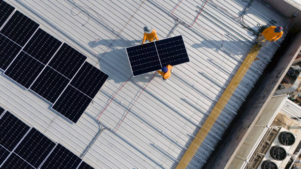 istock Aerial top view of a technician drone installing solar panels on the roof. 2151692850