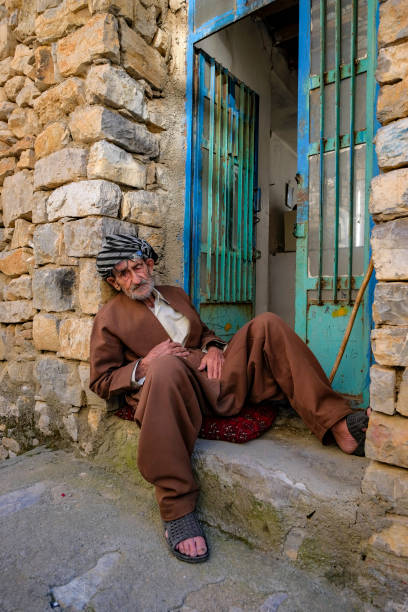 Uraman Takht, Iran - April 15, 2024: Portrait of a man sitting on a street in Uraman Takht in Kurdistan, Iran.