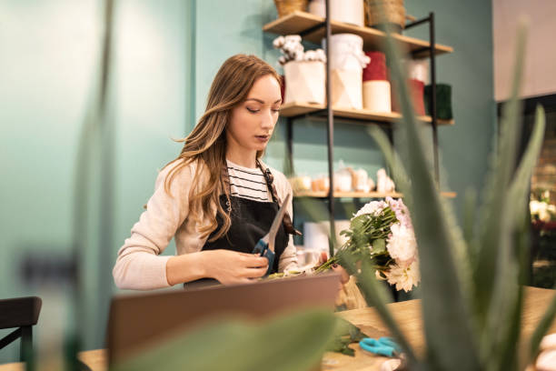 istock Cheerful Florist Crafting Bouquet at Counter 2151694191