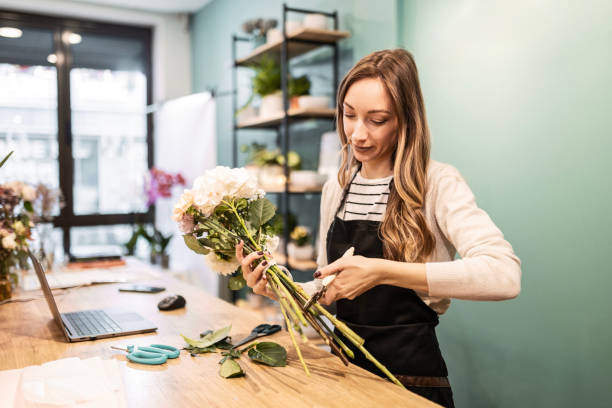 istock Young Florist Cutting Flowers with Joy 2151694199