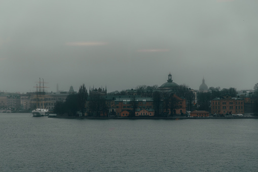 this was shot from the window of Fotografiska, over the river was a very gloomy and foggy landscape featuring buildings and boats