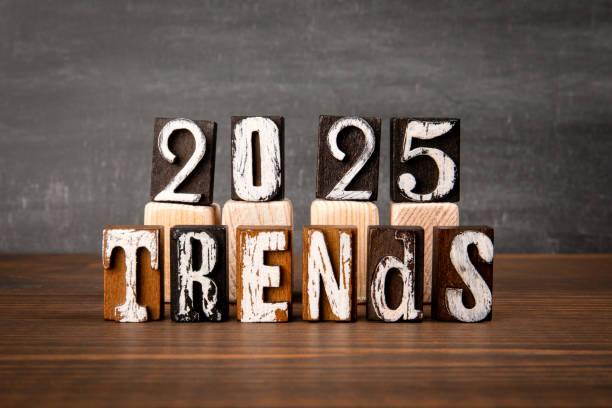 istock 2025 TRENDS. Alphabet blocks on wooden texture table 2151695144