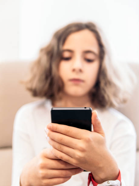 istock Young Girl Relaxing on Couch with Smartphone 2151697689